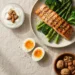 Pasto bilanciato ad alto contenuto proteico con salmone, uova, verdure e frutta secca per una dieta proteica efficace