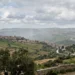 Nuvole scure e pioggia su paesaggio siciliano con instabilità meteo