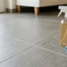 Dettaglio di fughe del pavimento pulite con rimedi naturali e flacone spray