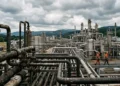 Impianto di estrazione gas con pipeline industriale sullo sfondo, paesaggio europeo