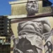 Murale del progetto Bitume sull’ex area industriale Ancione a Ragusa, simbolo della memoria produttiva della città