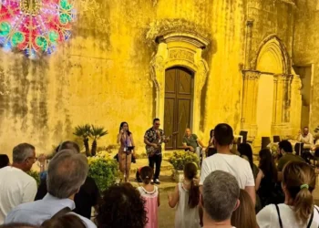 Pubblico assiste a un'esibizione musicale serale durante Ibla in Festa nel centro storico di Ragusa Ibla