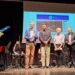 Cerimonia organizzata da Cna Pensionati Ragusa al teatro Don Bosco, con la consegna di riconoscimenti e l'omaggio a Paolino Gambuzza durante una serata dedicata a cultura, musica e memoria.