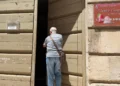 Ingresso del Museo Civico "L'Italia in Africa" di Ragusa con il portone socchiuso e una persona davanti all'entrata.