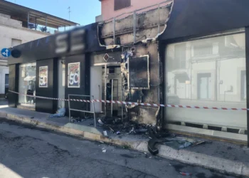 Negozio di abbigliamento danneggiato da un incendio a Vittoria, con la facciata annerita dalle fiamme e l'area transennata dopo l'intervento dei vigili del fuoco