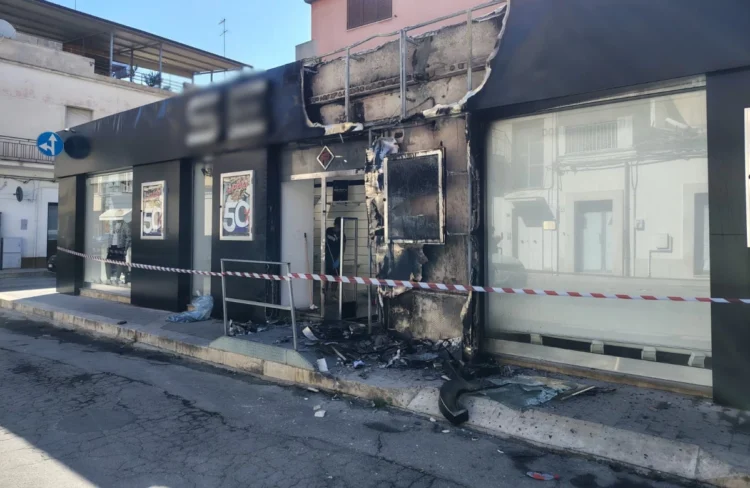 Negozio di abbigliamento danneggiato da un incendio a Vittoria, con la facciata annerita dalle fiamme e l'area transennata dopo l'intervento dei vigili del fuoco