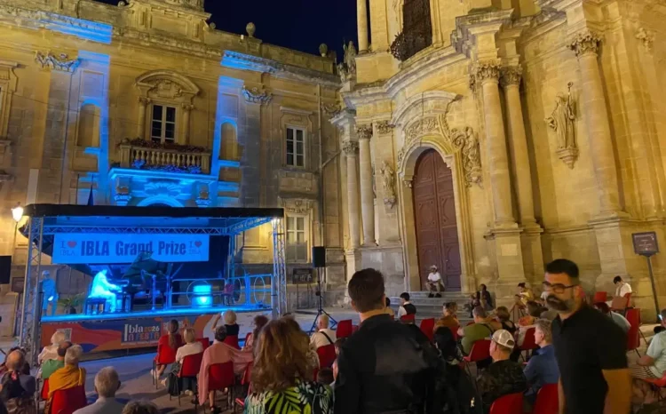 Pubblico assiste a un'esibizione dell'Ibla Grand Prize 2026 sul palco allestito in Piazza Pola, davanti alla Chiesa di San Giuseppe, nel centro storico di Ragusa Ibla.