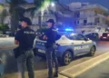 Agenti della Polizia di Stato accanto a una volante durante un servizio di controllo a Marina di Ragusa