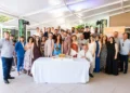 Foto di gruppo durante la celebrazione dei 18 anni di San Gregorio a Modica, con dipendenti, clienti, docenti universitari e il taglio della torta