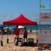 Due assistenti bagnanti in maglietta rossa sorvegliano la spiaggia di Marina di Ragusa accanto alla torretta di avvistamento