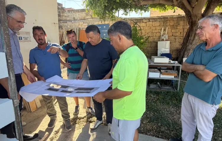 Ignazio Abbate e i tecnici durante un sopralluogo al cantiere del Tennis Club Scicli mentre esaminano le planimetrie dei lavori di riqualificazione finanziati dalla Regione Siciliana.