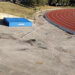 Materasso del salto in alto spostato e aste a terra accanto alla pista di atletica di Ragusa
