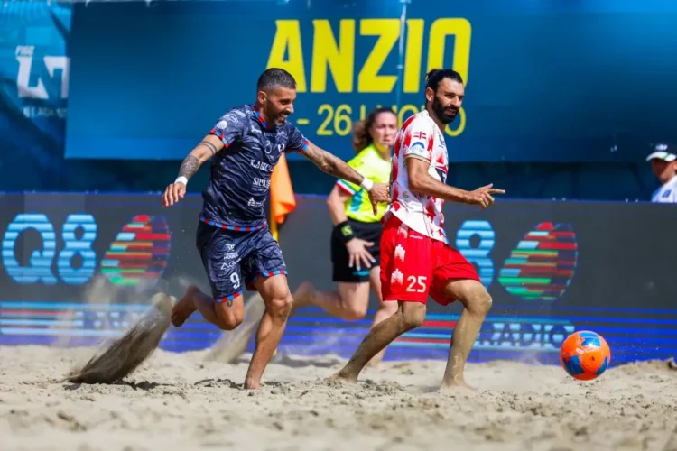 Due giocatori di beach soccer si contendono il pallone sulla sabbia durante una gara ufficiale ad Anzio