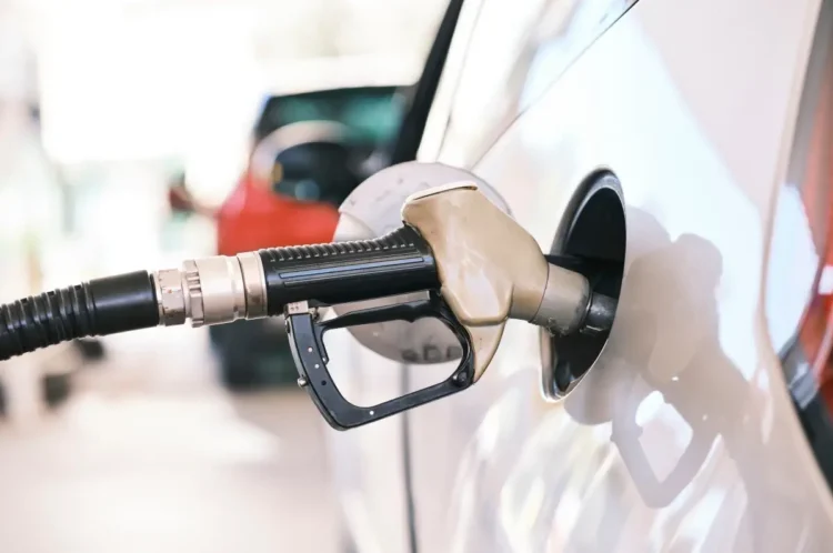 Pistola erogatrice inserita nel serbatoio di un'auto durante un rifornimento di benzina