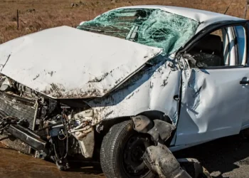 Auto bianca con il muso distrutto e il parabrezza sfondato dopo un incidente stradale.