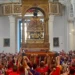 Portatori sollevano il simulacro di San Bartolomeo durante la Scinnuta, davanti ai fedeli nella chiesa di Giarratana.