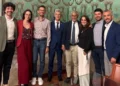 Delegazione di giovani e rappresentanti istituzionali in una sala comunale