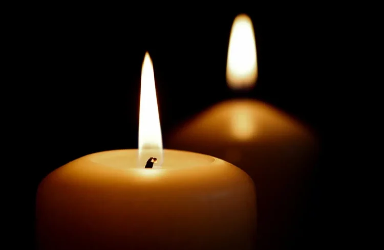 Due candele accese su sfondo nero, immagine simbolica di lutto per la morte di Alessio Giuga a Rosolini