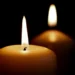 Due candele accese su sfondo nero, immagine simbolica di lutto per la morte di Alessio Giuga a Rosolini