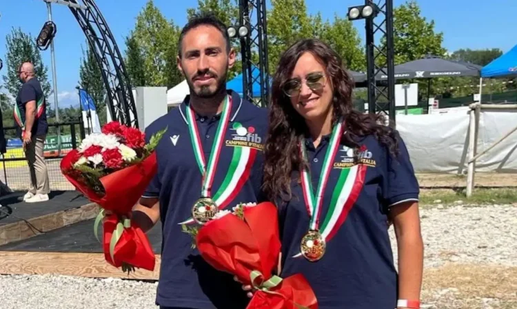 Due atleti di bocce Scicli con medaglie e mazzi di fiori durante la premiazione