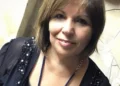 Enza Forti, maestra di Comiso, sorride all'obiettivo: capelli castani a caschetto, blusa scura ricamata e collana blu.