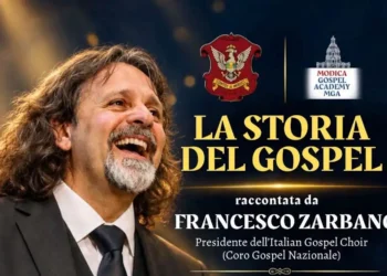 Logo della Modica Gospel Academy: un campanile barocco disegnato in rosso sopra il nome in rosso e blu e la sigla MGA