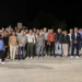 Decine di persone in posa di notte su una strada di campagna per l'accensione dell'illuminazione sulla Spinazza a Donnalucata