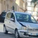 Fiat Panda argento con il muso danneggiato dopo l'incidente a Comiso, auto dei Carabinieri sullo sfondo