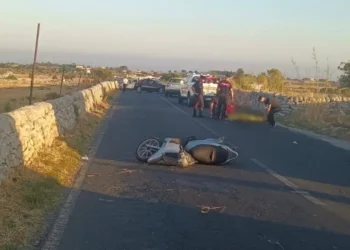 Scooter incidentato sull'asfalto dopo un incidente stradale a Modica, con carabinieri e mezzi di soccorso sul posto