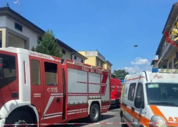 Autopompa dei vigili del fuoco e ambulanza in una strada transennata con nastro bianco e rosso, immagine di un incidente