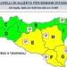 Mappa della Sicilia divisa in zone di allerta: gialla per E, F, G e H nel centro-sud-est, verde nel resto, icone di temporali