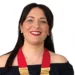 Michela Canto sorride con la fascia e i distintivi da presidente del Rotaract Club Pozzallo-Ispica