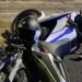 Santa Croce Camerina, moto bianca e nera a terra sull'asfalto di notte con il casco appoggiato sul serbatoio