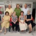 Otto persone in posa in una stanza di AIL Ragusa, accanto allo striscione dell’Associazione contro leucemie, linfomi e mieloma