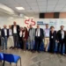 Delegazione dell’ASP di Ragusa in posa davanti al pannello di ExpoMedicina 2026, alle Ciminiere di Catania