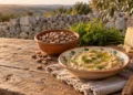 Fava cottoia di Modica secca in una ciotola e un piatto di maccu di fave. Immagine generata con intelligenza artificiale