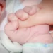 Genitore tiene in braccio un neonato