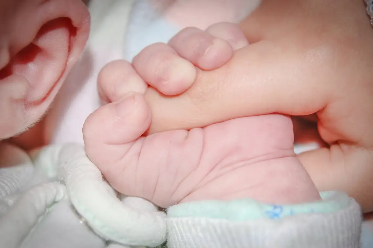 Genitore tiene in braccio un neonato
