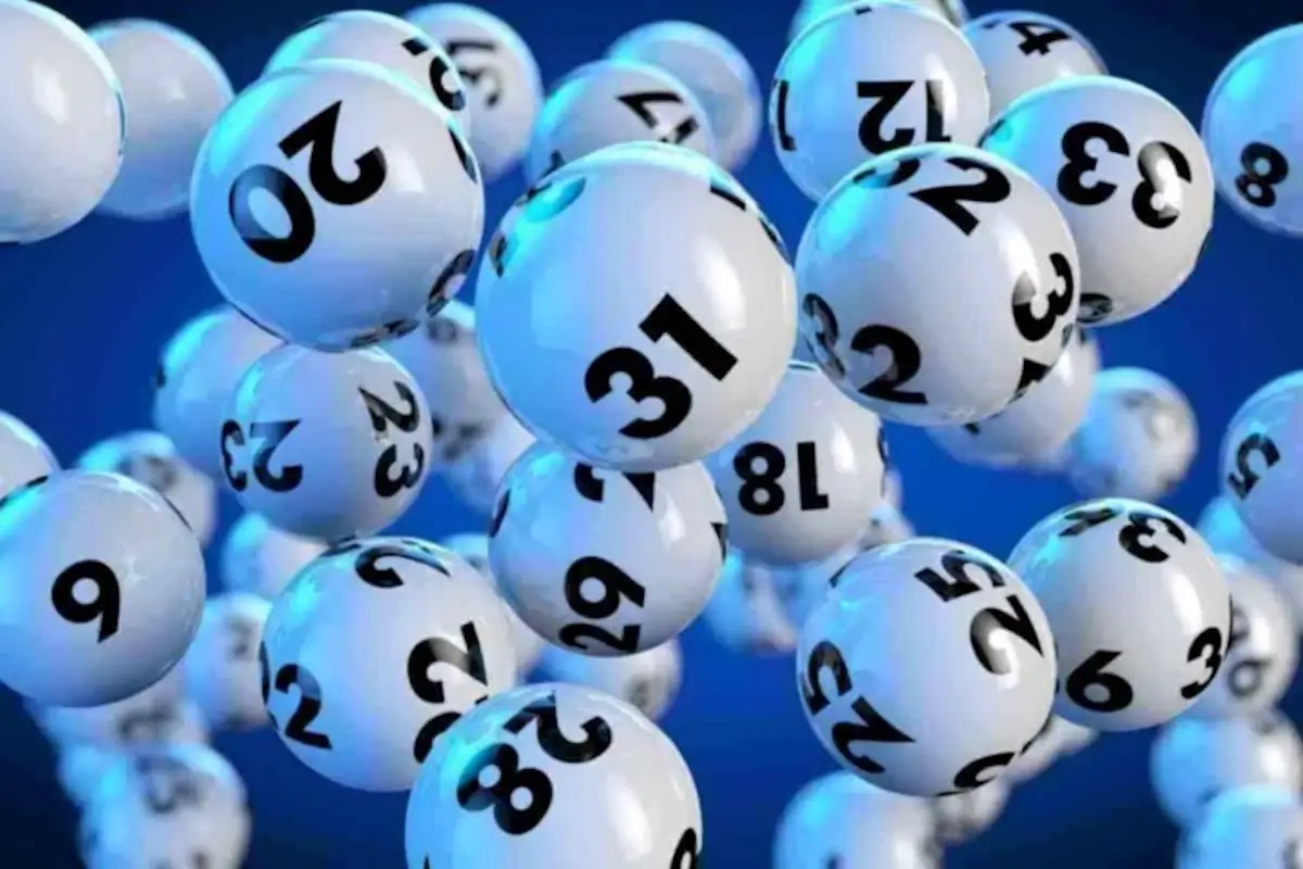 Palline bianche numerate da estrazione su sfondo blu, immagine simbolica di una vincita al 10eLotto