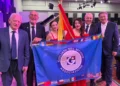 Silvia Di Falco e Cristina Gianino in abito rosso a Johannesburg, con quattro uomini, la bandiera siciliana e quella dei Giuliani nel Mondo