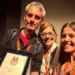 Simone Lucifora regge la targa Miglior soggetto del VerticalMovie 2026 per Atto '84, accanto a due donne sorridenti