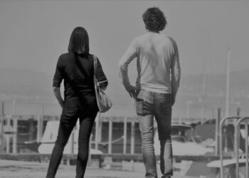 Un uomo e una donna di spalle su una banchina del porto, a qualche passo di distanza: foto simbolica sul bonus affitto