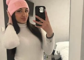 Carola Battaglia, giovane di Vittoria, in un selfie allo specchio con berretto rosa e maglione bianco a collo alto